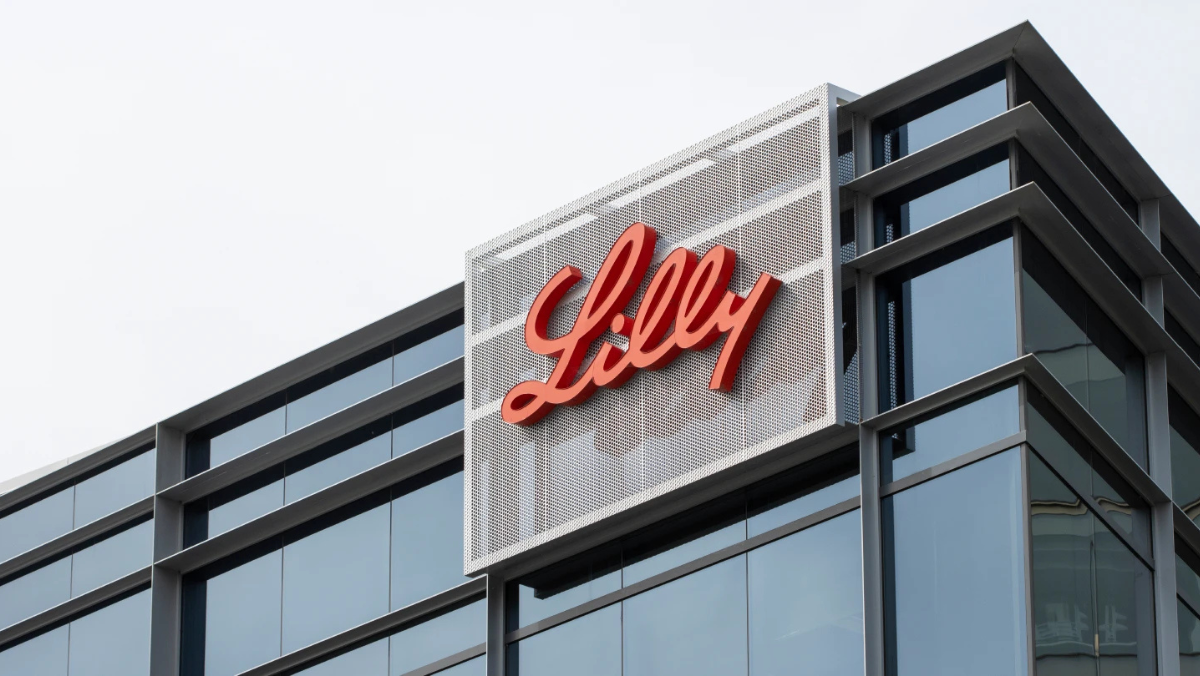 Eli Lilly corporate building with prominent red Lilly logo on modern glass façade.