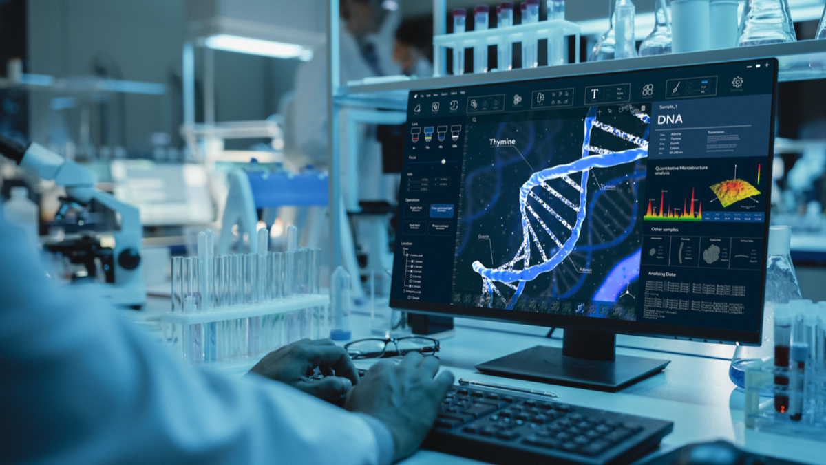 Scientist analyzing DNA models on a computer screen in an advanced genomic research lab